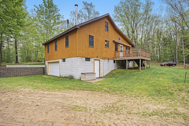 4900 N Railroad Ave, Pentwater, MI 49449 - view of property exterior with a deck, dirt driveway, a lawn, a garage, and stairway