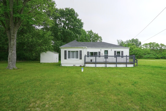 879 Carberry Rd, Niles, MI 49120 - rear view of house featuring a deck, a yard, a shingled roof, crawl space, and an outbuilding