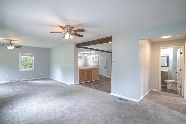 879 Carberry Rd, Niles, MI 49120 - unfurnished living room with dark carpet and a ceiling fan