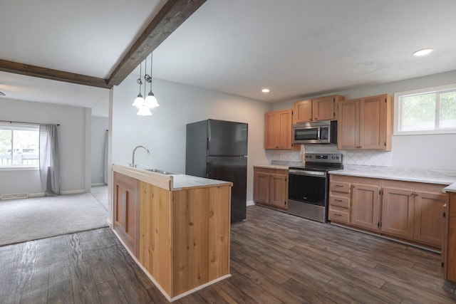 879 Carberry Rd, Niles, MI 49120 - kitchen with appliances with stainless steel finishes, beamed ceiling, dark wood-type flooring, tasteful backsplash, and light countertops