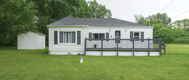879 Carberry Rd, Niles, MI 49120 - back of property featuring a deck, roof with shingles, a lawn, crawl space, and a shed