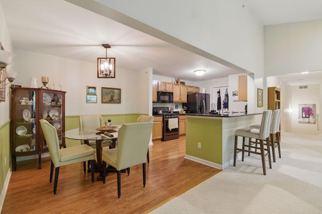 9285 Nature View Ln, Ypsilanti, MI 48197 - dining space with light wood-style floors and a chandelier