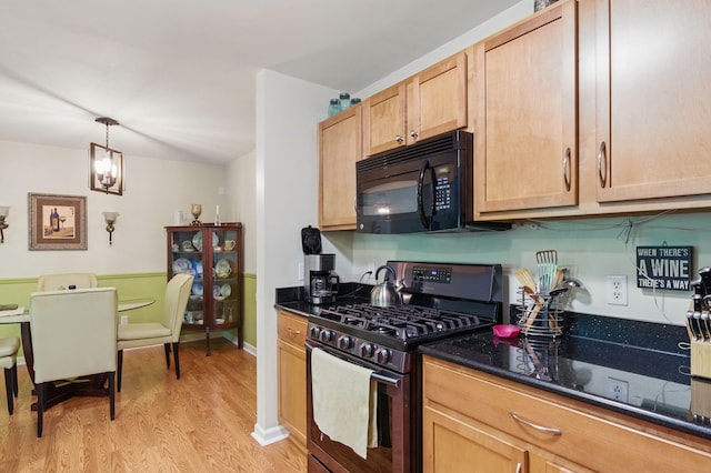9285 Nature View Ln, Ypsilanti, MI 48197 - kitchen featuring stainless steel gas stove, black microwave, light wood-type flooring, dark stone counters, and pendant lighting