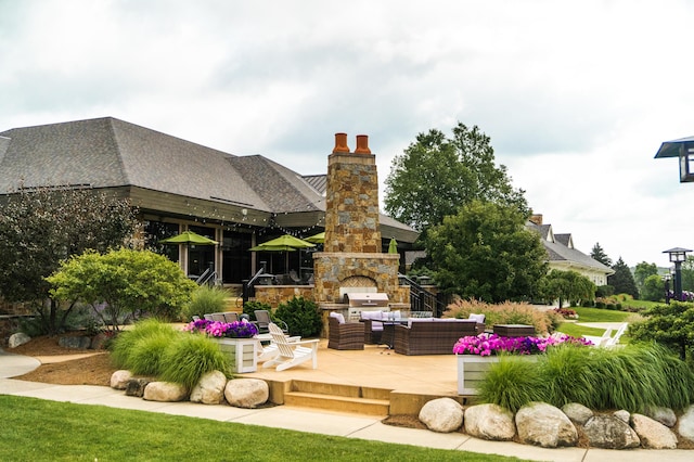 2583 Ravines Trail Dr SW, Byron Center, MI 49315 - view of patio with an outdoor living space with a fireplace