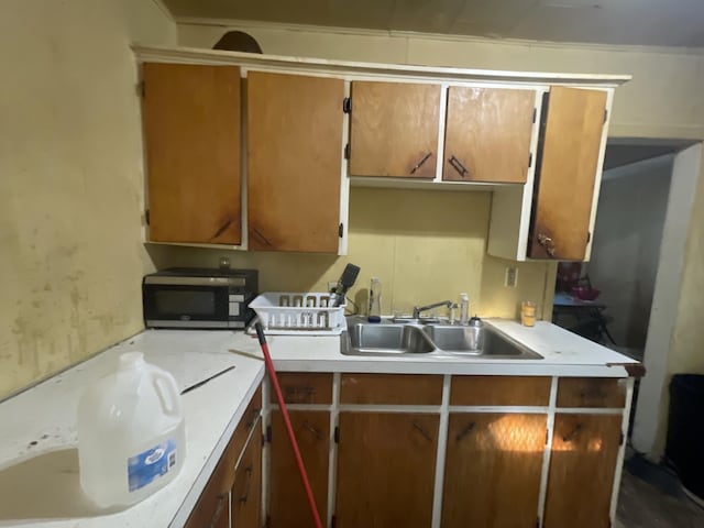 2645 Howden St, Muskegon Heights, MI 49444 - kitchen featuring stainless steel microwave, light countertops, and brown cabinetry