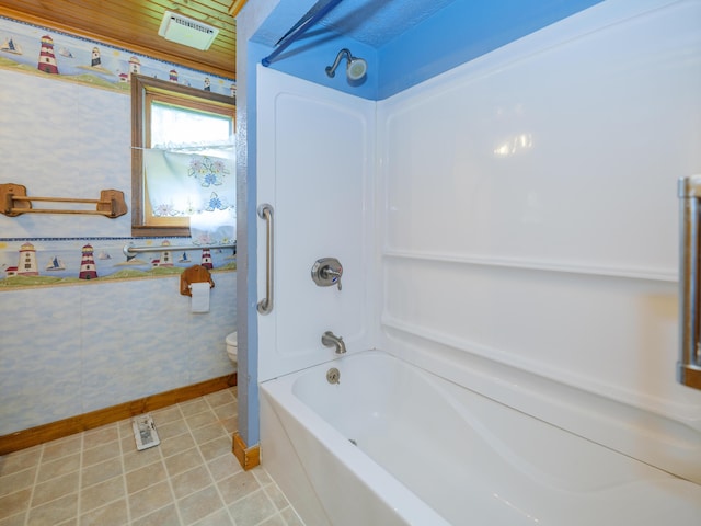 12391 Sunset Dr, Plainwell, MI 49080 - bathroom with baseboards, toilet, shower / bath combination, tile patterned floors, and wallpapered walls