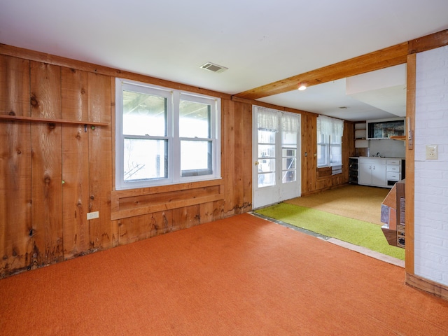 12391 Sunset Dr, Plainwell, MI 49080 - unfurnished living room featuring carpet and wooden walls