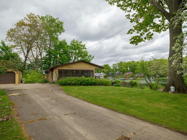 12391 Sunset Dr, Plainwell, MI 49080 - view of front of property featuring a front yard and driveway