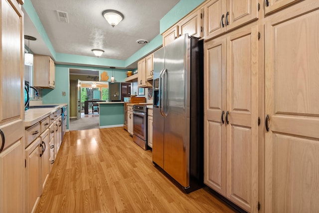 1119 Wesaw Rd, Niles, MI 49120 - kitchen with stainless steel appliances, a sink, light countertops, light wood-style flooring, and under cabinet range hood