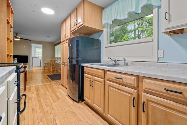 1119 Wesaw Rd, Niles, MI 49120 - kitchen featuring black appliances, a sink, light wood-type flooring, a ceiling fan, and light brown cabinets