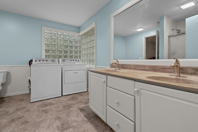 1119 Wesaw Rd, Niles, MI 49120 - full bathroom featuring independent washer and dryer, a stall shower, wainscoting, and double vanity