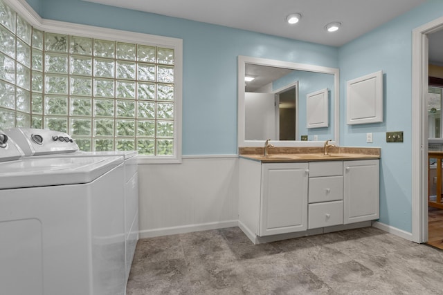 1119 Wesaw Rd, Niles, MI 49120 - washroom with washer and clothes dryer, a sink, baseboards, and a wainscoted wall