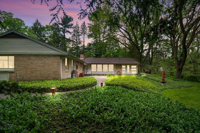 1119 Wesaw Rd, Niles, MI 49120 - view of front of house with brick siding, a patio area, and a chimney
