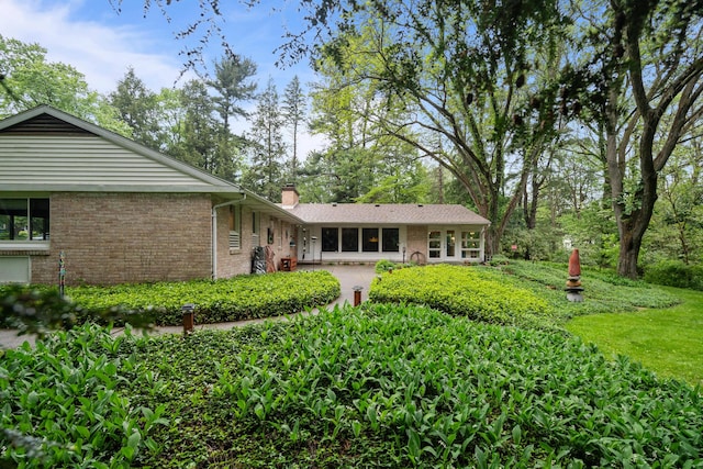 1119 Wesaw Rd, Niles, MI 49120 - back of property featuring brick siding, a chimney, and a patio