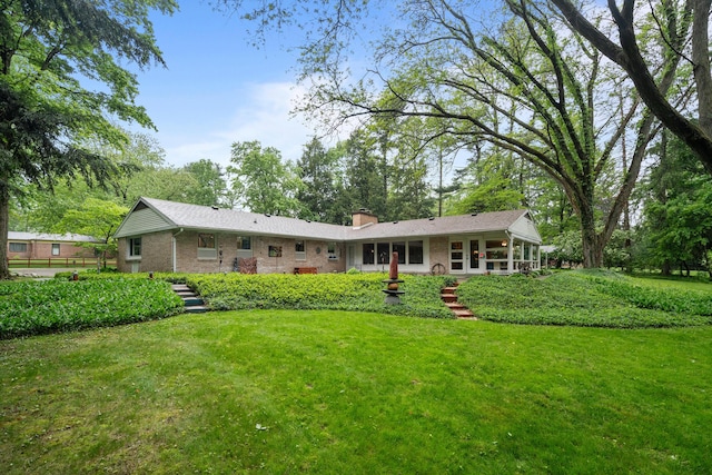 1119 Wesaw Rd, Niles, MI 49120 - rear view of property featuring brick siding, a yard, and a chimney