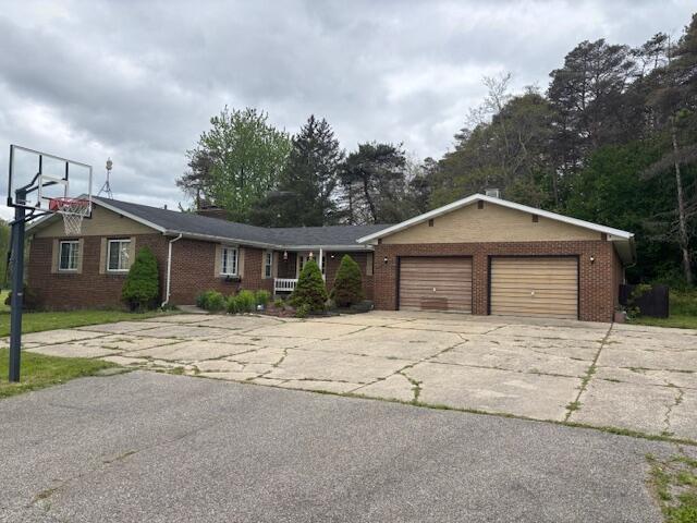18593 30th Ave, Barryton, MI 49305 - ranch-style house with brick siding, an attached garage, and concrete driveway