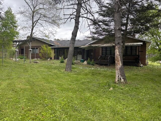 18593 30th Ave, Barryton, MI 49305 - back of house featuring a lawn