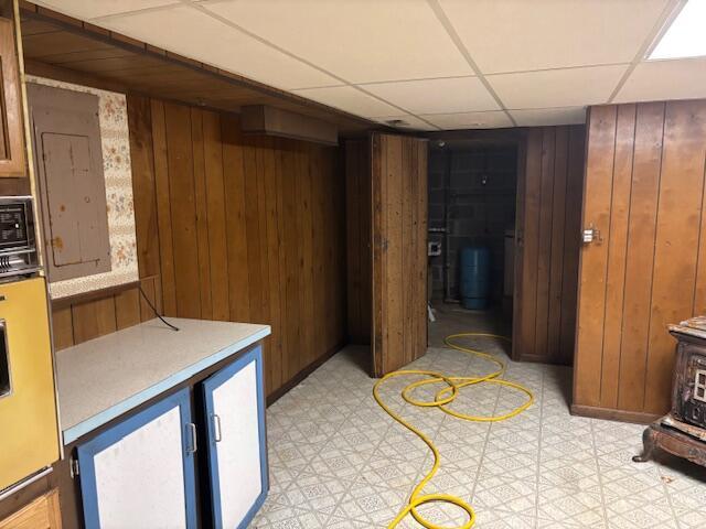 18593 30th Ave, Barryton, MI 49305 - finished below grade area with wood walls, a drop ceiling, light floors, and a water pressure tank