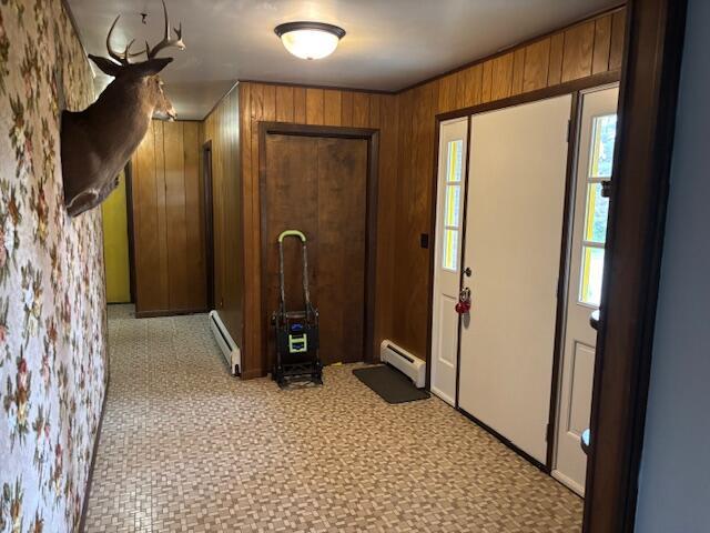 18593 30th Ave, Barryton, MI 49305 - corridor featuring a baseboard radiator, wood walls, a baseboard heating unit, and baseboards