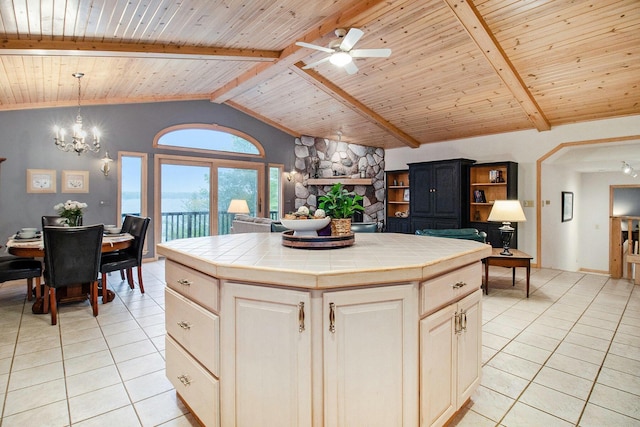 6818 W Vesper Dr, Ludington, MI 49431 - kitchen featuring tile countertops, light tile patterned floors, wooden ceiling, ceiling fan, and a kitchen island