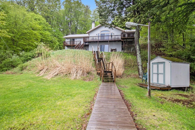 6818 W Vesper Dr, Ludington, MI 49431 - back of house with stairs, a deck, a lawn, and a chimney