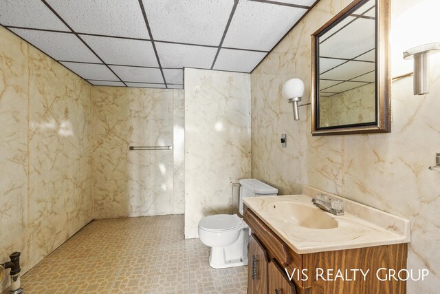 17933 N Shore Estates Rd, Spring Lake, MI 49456 - bathroom featuring toilet, tile patterned floors, a drop ceiling, and vanity