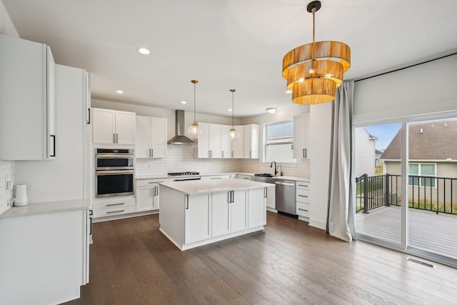 331 Honey Tree Way, Ann Arbor, MI 48103 - kitchen with stainless steel appliances, wall chimney exhaust hood, tasteful backsplash, a kitchen island, and recessed lighting