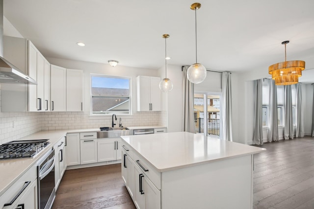 331 Honey Tree Way, Ann Arbor, MI 48103 - kitchen with appliances with stainless steel finishes, wall chimney range hood, dark wood-type flooring, tasteful backsplash, and recessed lighting