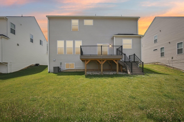 331 Honey Tree Way, Ann Arbor, MI 48103 - back of house at dusk featuring stairs, a deck, and a lawn