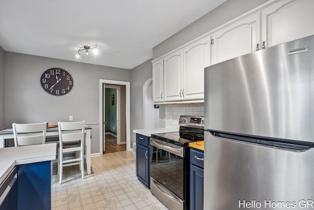 2052 Gorham Dr SE, East Grand Rapids, MI 49506 - kitchen featuring appliances with stainless steel finishes, blue cabinetry, white cabinets, light countertops, and decorative backsplash
