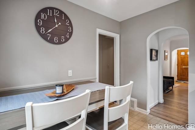 2052 Gorham Dr SE, East Grand Rapids, MI 49506 - dining space featuring arched walkways and baseboards