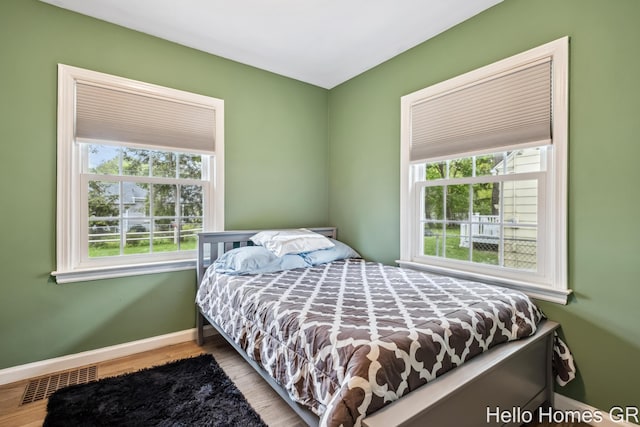 2052 Gorham Dr SE, East Grand Rapids, MI 49506 - bedroom with multiple windows, baseboards, and wood finished floors