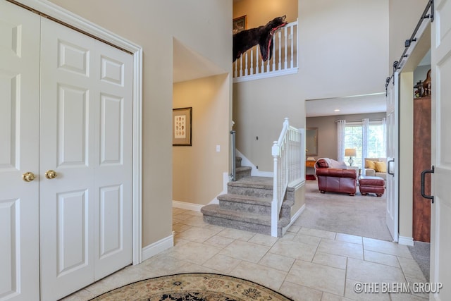 1705 Fritz St, Marne, MI 49435 - entrance foyer with light colored carpet, stairway, and a high ceiling
