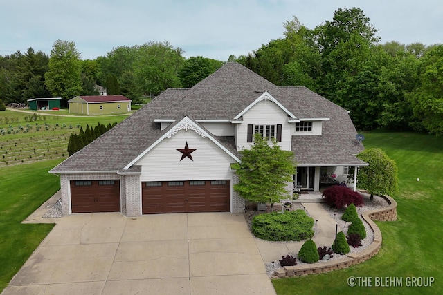 1705 Fritz St, Marne, MI 49435 - view of front of property with concrete driveway, a front lawn, a porch, and roof with shingles