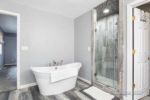1705 Fritz St, Marne, MI 49435 - bathroom featuring a shower stall, wood finished floors, and a freestanding tub