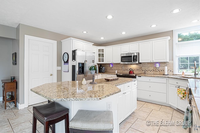 1705 Fritz St, Marne, MI 49435 - kitchen featuring appliances with stainless steel finishes, decorative backsplash, white cabinets, and recessed lighting