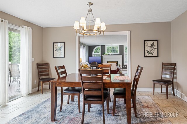 1705 Fritz St, Marne, MI 49435 - dining space featuring a chandelier, plenty of natural light, and light tile patterned flooring
