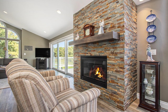 14776 Park Ct, Grand Haven, MI 49417 - living area with wood finished floors, lofted ceiling, plenty of natural light, a large fireplace, and recessed lighting