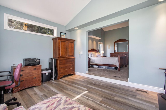 14776 Park Ct, Grand Haven, MI 49417 - bedroom with light wood-type flooring, an office area, baseboards, and high vaulted ceiling