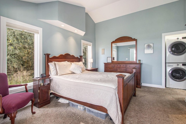 14776 Park Ct, Grand Haven, MI 49417 - bedroom with stacked washer / dryer, carpet floors, multiple windows, vaulted ceiling, and baseboards