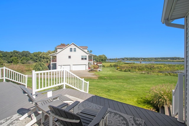 14776 Park Ct, Grand Haven, MI 49417 - wooden deck featuring an attached garage, a water view, a yard, and driveway