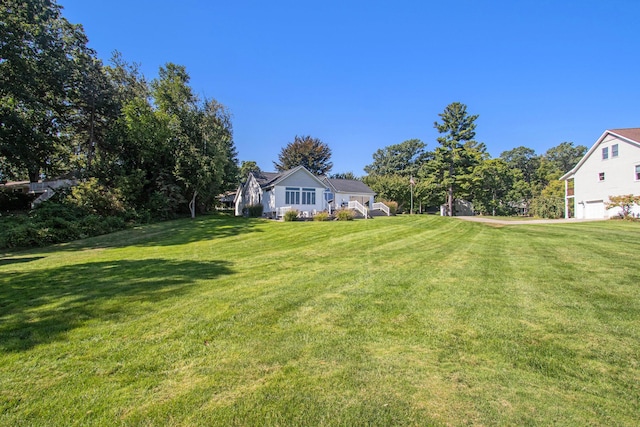 14776 Park Ct, Grand Haven, MI 49417 - view of grassy yard featuring an attached garage