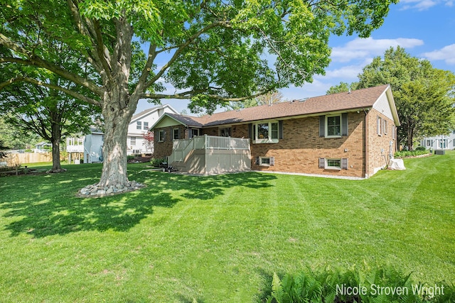 4124 Cummings Ct NW, Grand Rapids, MI 49534 - back of house featuring brick siding, a lawn, and a deck