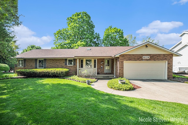 4124 Cummings Ct NW, Grand Rapids, MI 49534 - ranch-style home with brick siding, a front yard, a garage, driveway, and a porch
