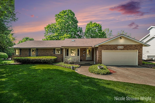 4124 Cummings Ct NW, Grand Rapids, MI 49534 - single story home with brick siding, a porch, a garage, a front yard, and driveway
