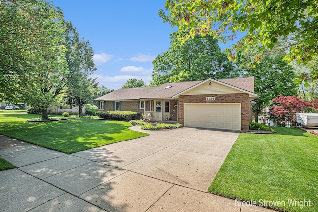 4124 Cummings Ct NW, Grand Rapids, MI 49534 - single story home featuring a garage, a front yard, brick siding, and concrete driveway