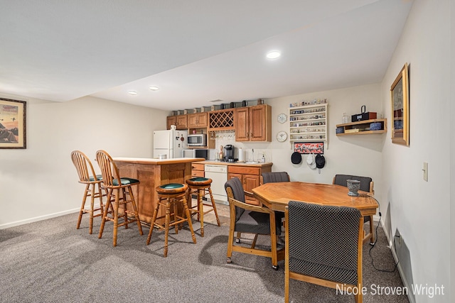 4124 Cummings Ct NW, Grand Rapids, MI 49534 - dining room featuring wet bar, light carpet, baseboards, and recessed lighting