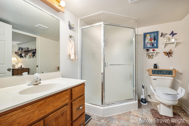 4124 Cummings Ct NW, Grand Rapids, MI 49534 - bathroom featuring vanity, toilet, a shower stall, stone finish flooring, and baseboards