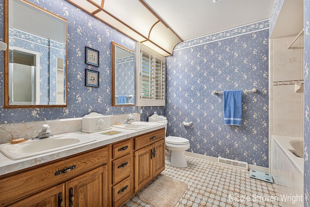 4124 Cummings Ct NW, Grand Rapids, MI 49534 - full bathroom featuring double vanity, toilet, tile patterned floors, shower / bath combination, and wallpapered walls