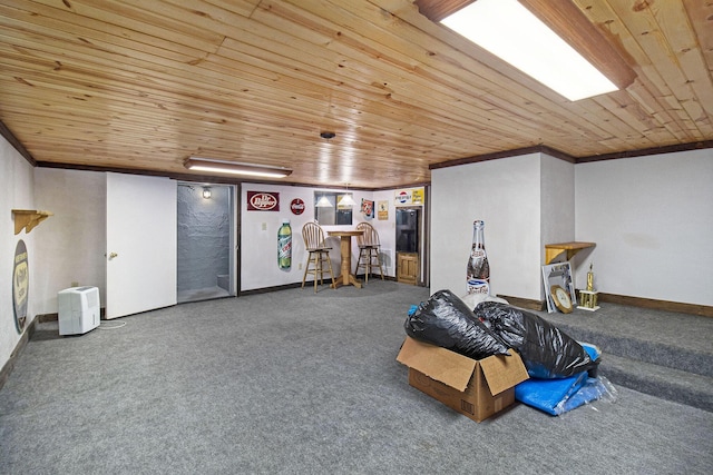 7034 W Dewey Rd, Ludington, MI 49431 - finished below grade area featuring carpet flooring, wooden ceiling, baseboards, and ornamental molding